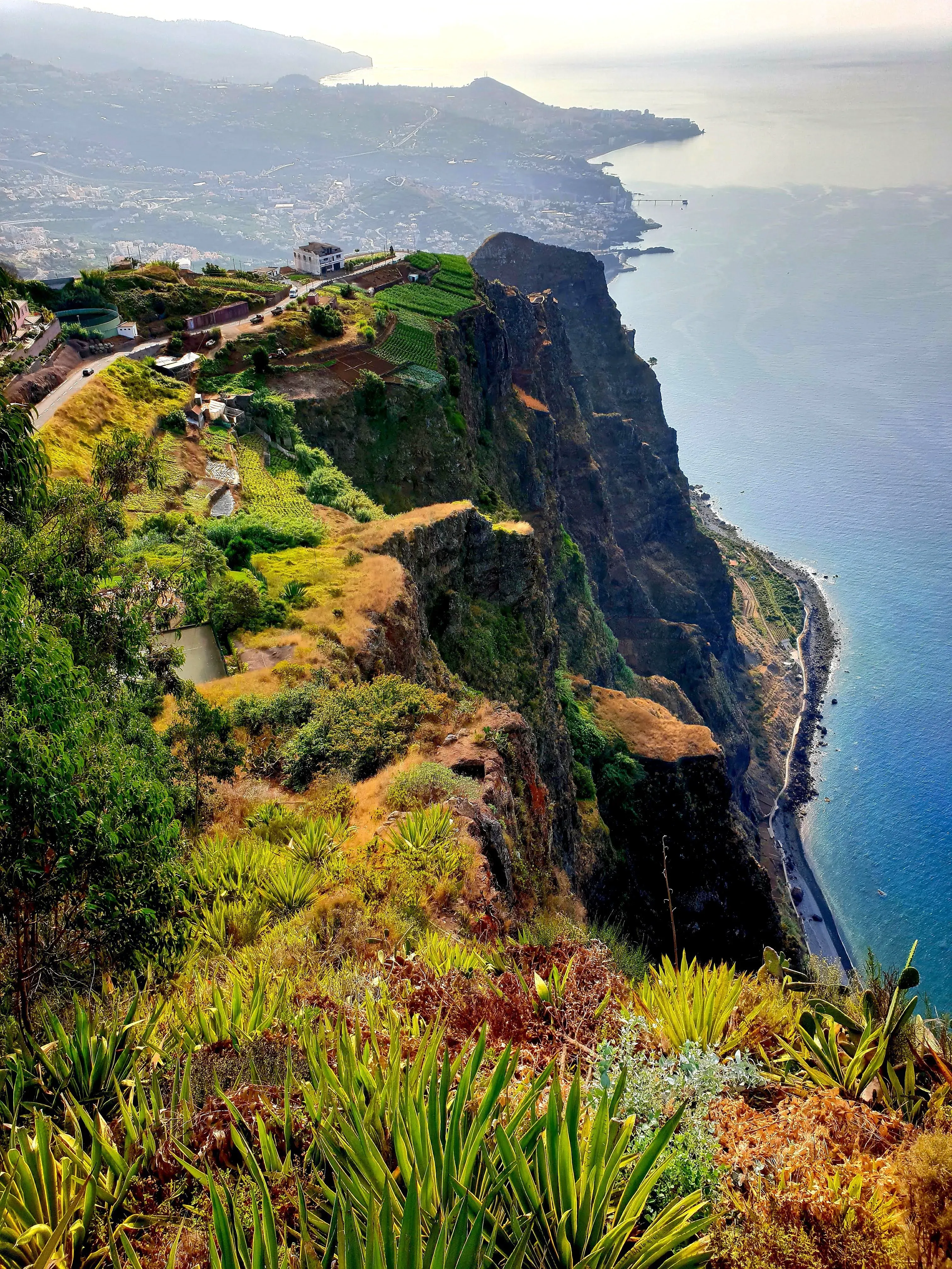 A teleférico cabin descending sheer cliffs to the coast